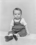 Photograph: [Toddler boy in overalls, boots and a short-sleeve shirt, 5]
