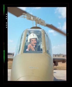 Primary view of object titled '[Iranian official sitting in a Cobra helicopter]'.