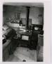Photograph: [A stove inside of a log cabin]