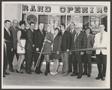 Photograph: [Photograph of a group of people cutting a Grand Opening ribbon]