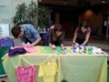 Photograph: [Three students decorating t-shirts at 2013 Clothesline Project]