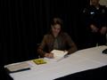 Photograph: [Woman signing books, 2011 E&D conference]