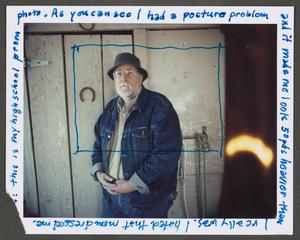 Primary view of object titled '[Man in a jean jacket and hat with writing along the frame]'.