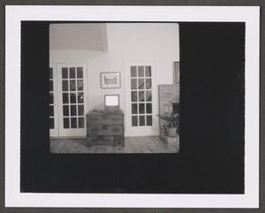 Primary view of object titled '[Photograph of a room with two doors, a dresser and a fireplace, 2]'.