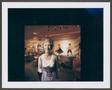 Photograph: [Cut-out photograph of a woman standing in a restaurant]