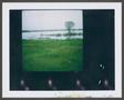 Photograph: [Field next to a body of water]
