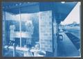 Photograph: [Clothes hanging in business window, 2]