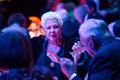 Photograph: [A woman conversing with others at the UNT College of Music Gala]