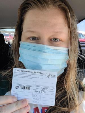 Primary view of object titled '[Katy Allred with vaccination card]'.