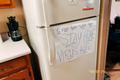 Primary view of [COVID reminders sign on refrigerator]