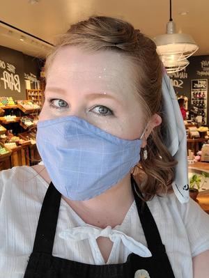 Primary view of object titled '[Katy Allred wearing a face mask while working at LUCH in Houston]'.