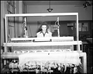 Primary view of object titled '[Dora Katherine Adams working at loom at North Texas State Teachers College]'.