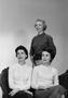 Photograph: [Three housewives smiling for their group picture]