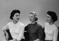 Photograph: [Three women conversing during portrait session]