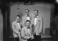 Photograph: [Four men dressed in bow-tie tuxedos]