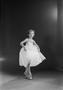 Photograph: [Suzie De Shazo posing in ballet attire, on pointe, holding her skirt]
