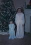 Photograph: [Two girls in front of a Christmas tree]