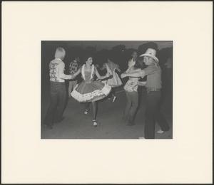 Primary view of object titled '[Square dancers exchanging partners on the Denton Square]'.