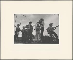 Primary view of object titled '[A band performing on an outdoor stage]'.
