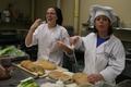 Photograph: [SMHM students slice bread at The Club]