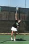 Photograph: [UNT women's tennis player hits ball during match]