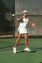 Photograph: [Idalina Franca hits ball during tennis match]