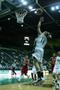 Photograph: [UNT women's basketball player throws ball toward net during game]