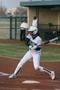 Photograph: [North Texas softball player bats during game]