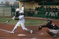 Photograph: [North Texas softball player bats during game, 2]