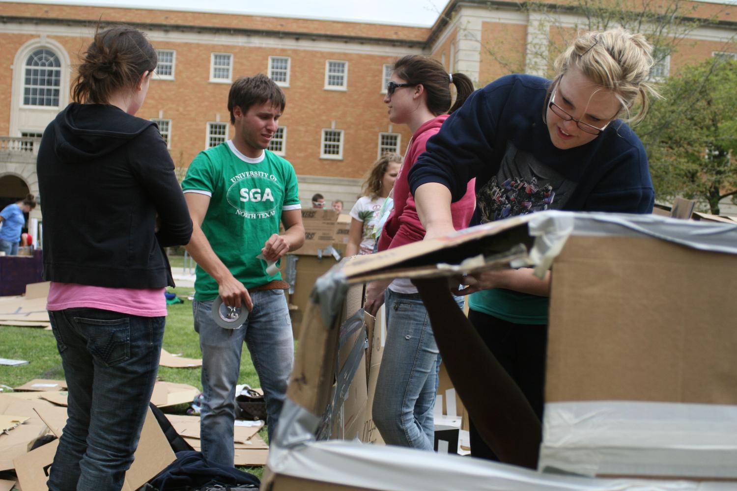 [Students build cardboard homes during Shack-a-thon fundraising event]
                                                
                                                    [Sequence #]: 1 of 1
                                                