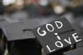 Photograph: [Student wears "God I Love" cap during UNT's 2008 graduation ceremony]