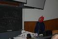 Photograph: [Man wears devil hat in UNT classroom]