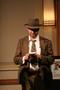 Photograph: [Photograph of a man in detective costume at murder mystery dinner]