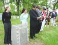 Photograph: [People stand at John Abston graveside ceremony]