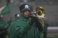 Photograph: [Man playing trombone at a football game]