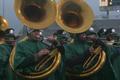 Photograph: [Sousaphone players performing at a football game]