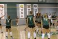Photograph: [UNT Women's Volleyball team faces opposing team on the court]