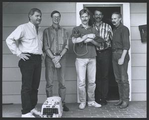 Primary view of object titled '[Photograph of five men and cat]'.