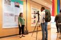 Photograph: [Morgan Gieringer being interviewed at LGBTQ exhibit]