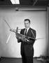 Photograph: [Photograph of a Kenneth Wernicke holding a airplane model]