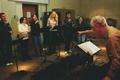 Photograph: [Choir director conducts ensemble practice]