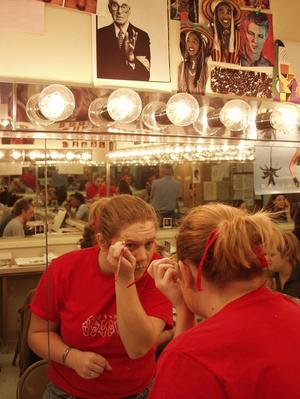 Primary view of object titled '[Actor 4 applies stage makeup]'.