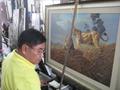 Photograph: [Man with lion painting in Thailand classroom]