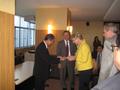Photograph: [Gretchen Bataille and man exchange item at NIDA delegation meeting]