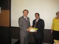 Photograph: [Vish Prasad receives gifts at NIDA delegation meeting]