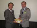 Photograph: [Earl Gibbons receives gifts at NIDA delegation meeting]