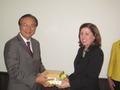 Photograph: [UNT faculty member receives gifts at NIDA delegation meeting]