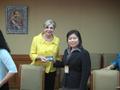 Primary view of [Woman 4 receives gift from Gretchen Bataille at Thailand delegation meeting]