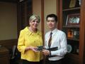 Photograph: [Man 6 receives gift from Gretchen Bataille at Thailand delegation me…