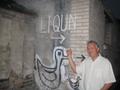 Primary view of [UNT faculty member poses with "liqun" graffiti]